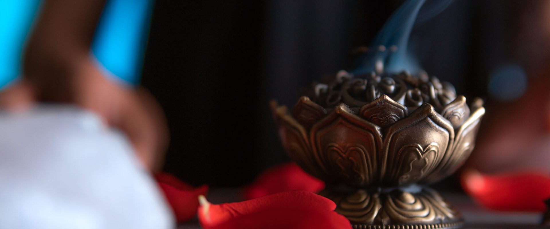 Close-up of hands lighting an incense, witch on the day of the dead performing a cleansing ritual, Halloween, spiritual beliefs, white magic
